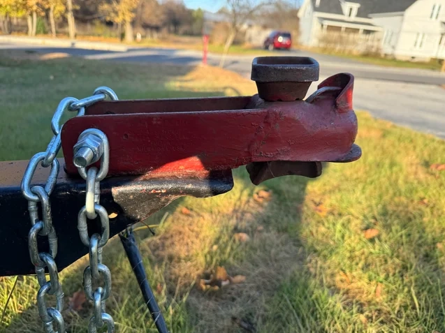 The trailer coupler latch is damaged, rusted, or the connection is unstable