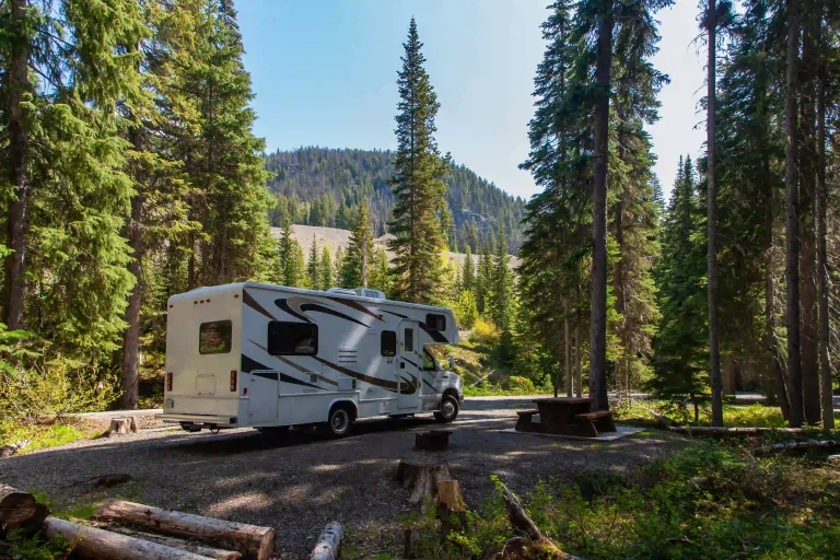 1-beautiful-campsite-mountains-with-rv-wooden-bench